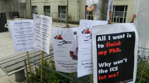 Placards explaining why the protest outside Michael Arthur's leaving party was taking place